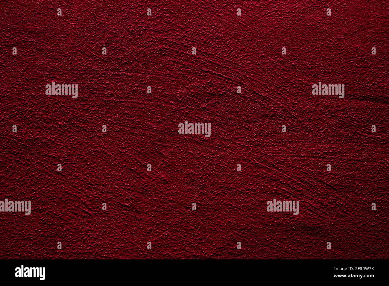 Crimson colored wall background with textures of different shades of