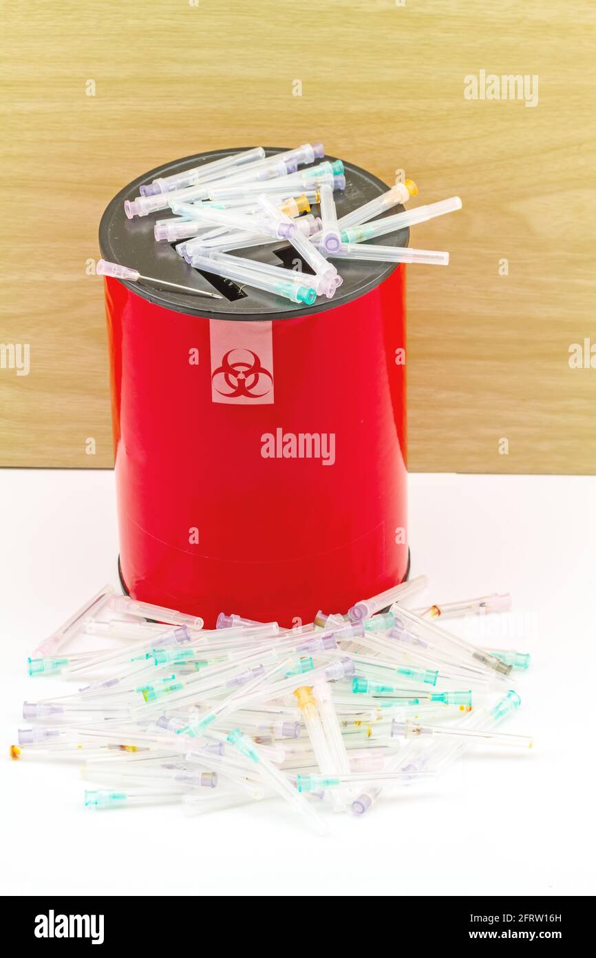 Many needle in red disposal boxes on white background Stock Photo Alamy