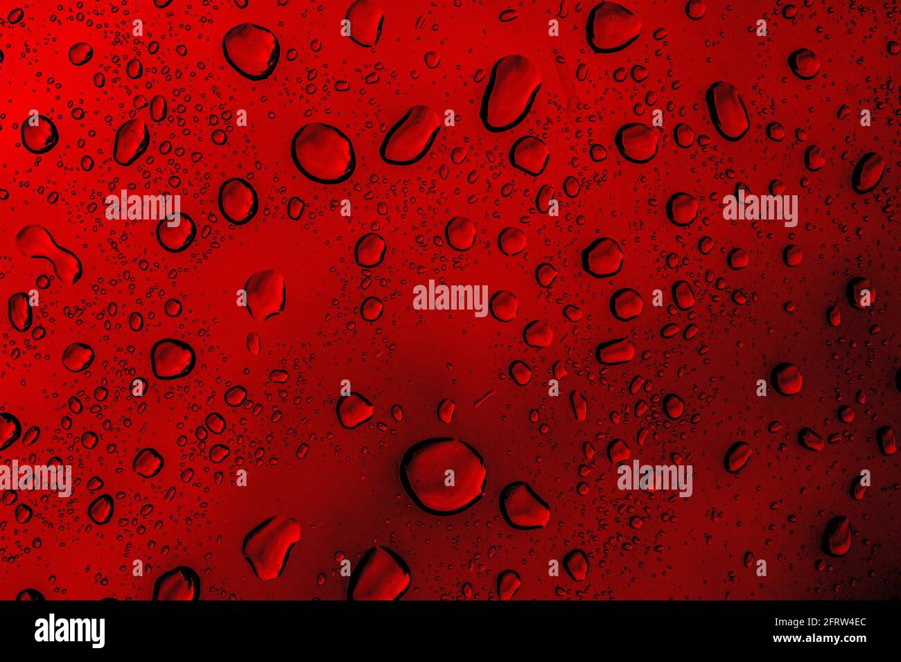 Red abstract background, red rain droplets on a window Stock Photo