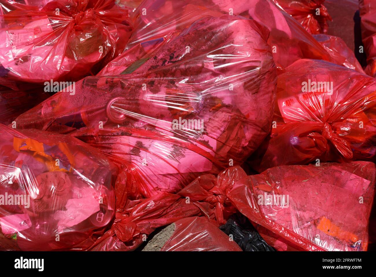full frame background of red plastic trash bags with generic