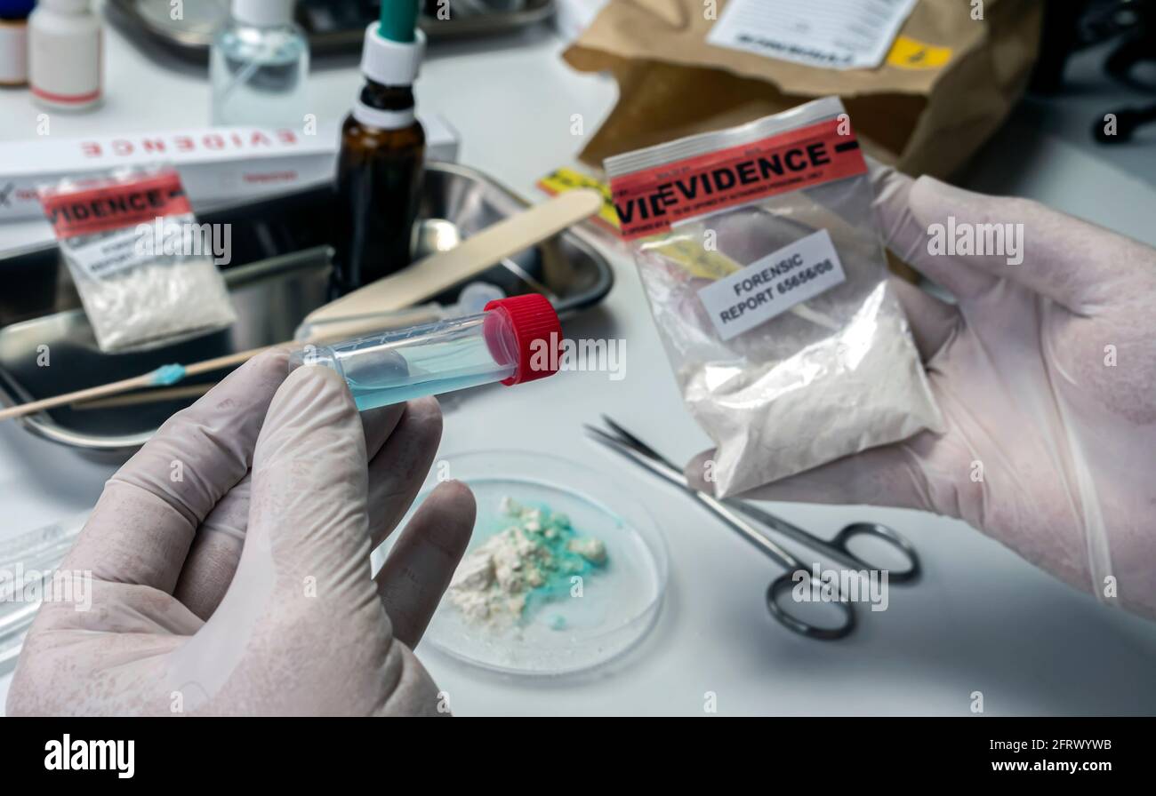 Police scientist holds drug-positive swab, crime lab, concept image Stock Photo