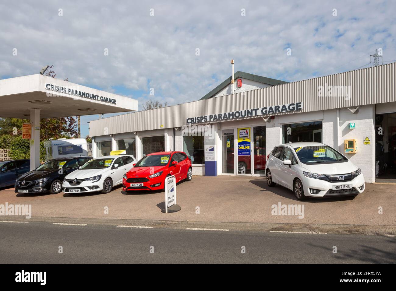 Second hand car sales on garage forecourt of motor dealership, Crisps Paramount Garage, Knodishall, Suffolk, England, UK Stock Photo
