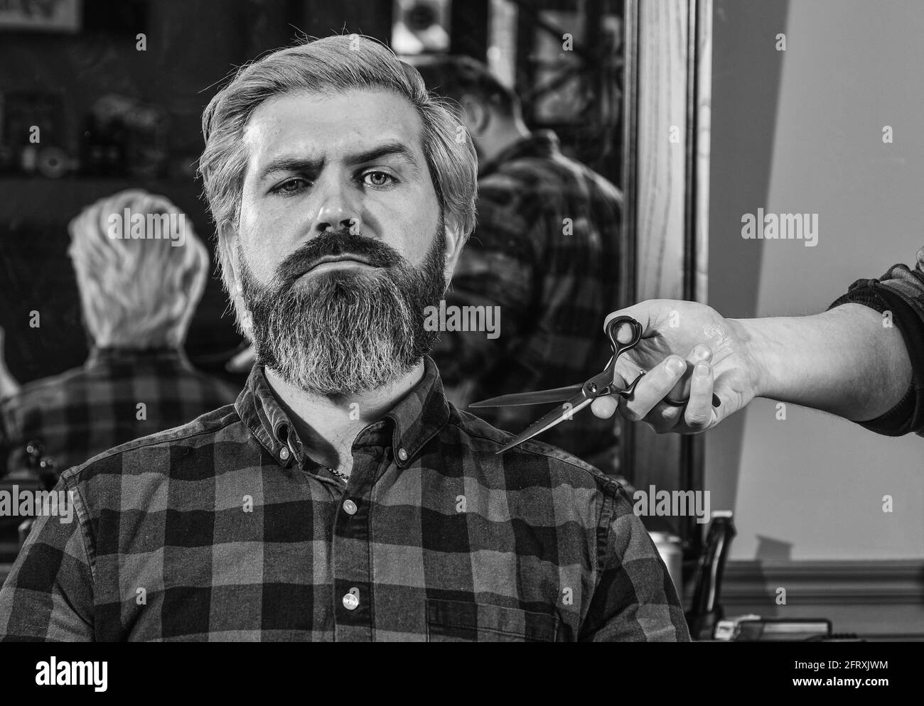 Making hair look magical. hairdresser cutting hair of male client. Hairstylist serving client at barber shop. Personal stylist barber. retro and Stock Photo