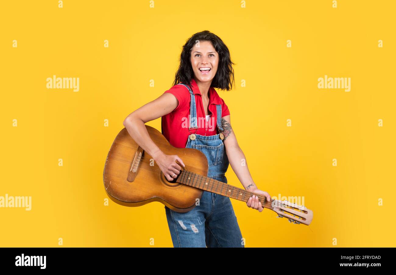 teacher of music. happy beautiful lady playing the guitar. music and vocal. female country singer. cheerful woman sing and play. girl with acoustic Stock Photo