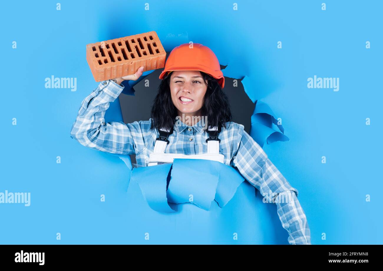 Building Assistant builder assistant wear protective helmet. girl in workshop uniform ...