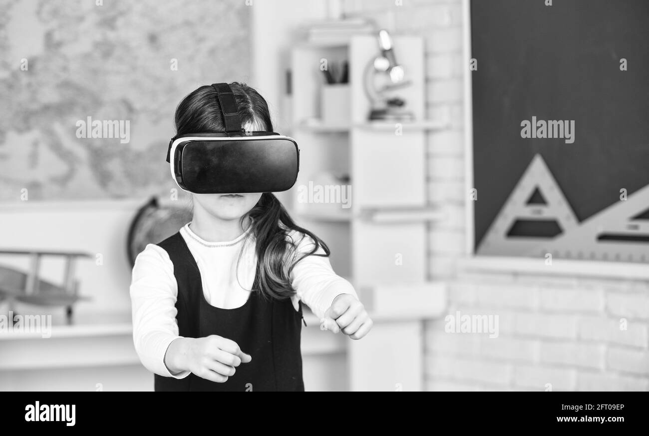 Go around obstacles. Virtual classes. Driving lessons. Science Class. VR technology. schoolgirl using virtual reality helmet. Virtual reality headset Stock Photo