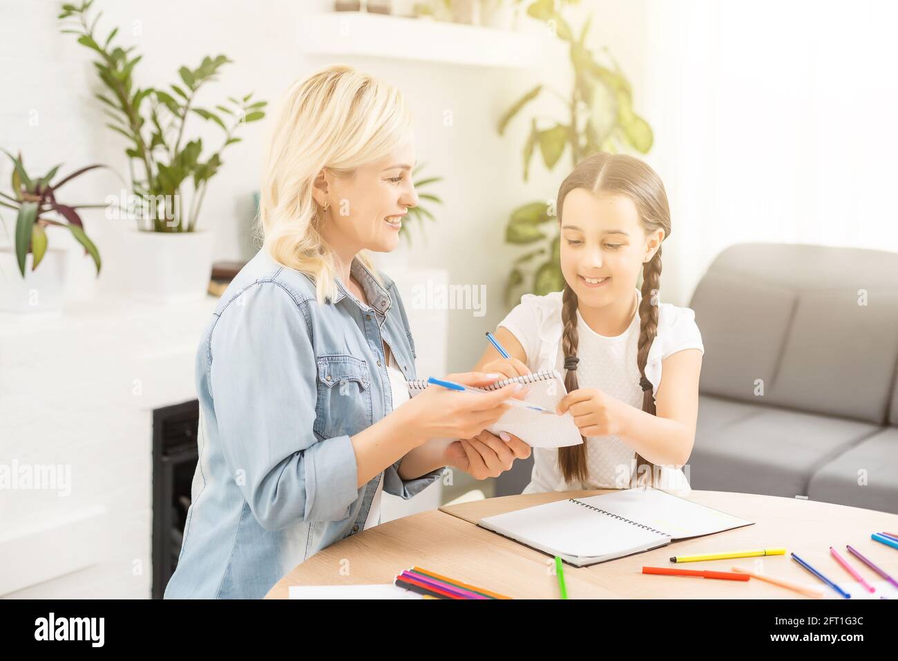 Mother and daughter spending time together at home drawing Stock Photo ...
