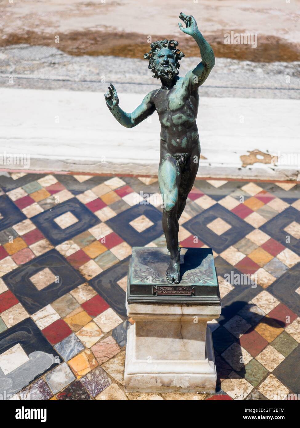 Bronze statue of a dancing faun in the House of the Faun (Casa del Fauno) - Pompeii archaeological site, Italy Stock Photo