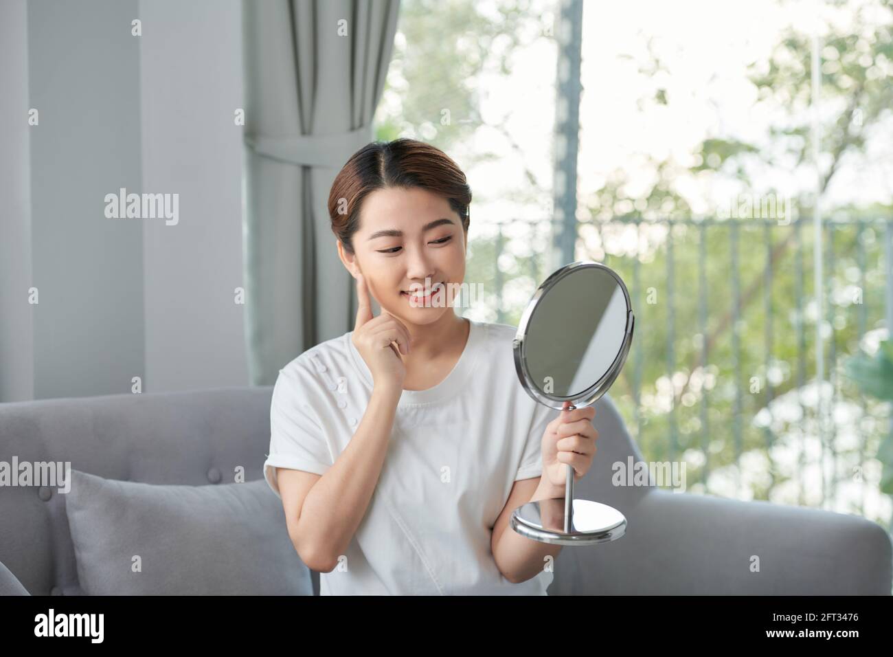 Beauty skin care. Young beautiful asian girl touching her face before ...