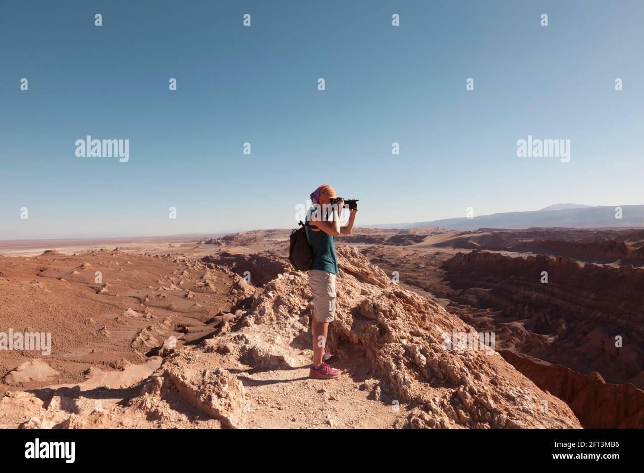 A tourist takes landscape photographs of the amazing desert landscape near San Pedro De Atacama, Chile. Stock Photo
