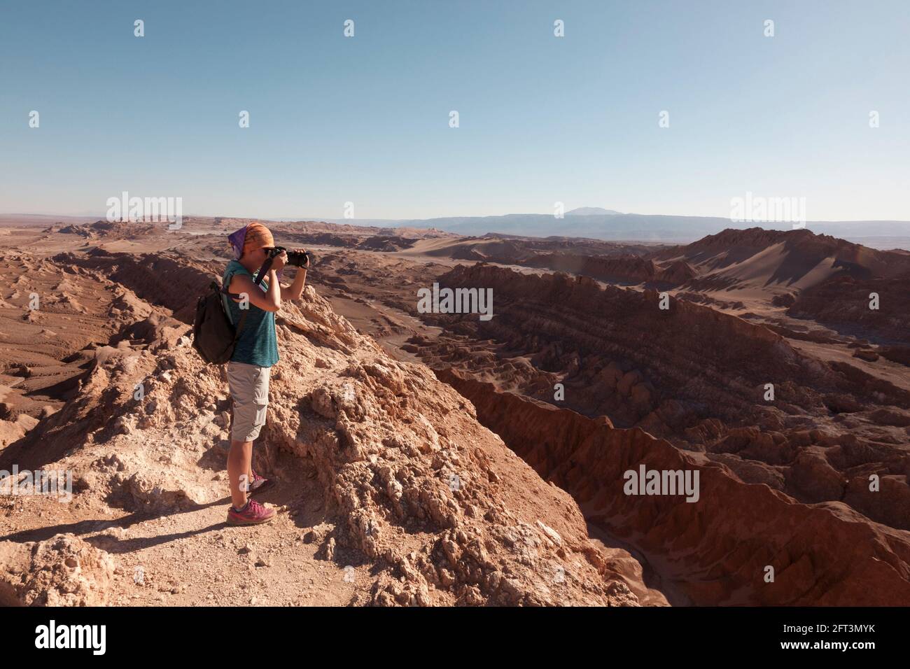 A tourist takes landscape photographs of the amazing desert landscape near San Pedro De Atacama, Chile. Stock Photo