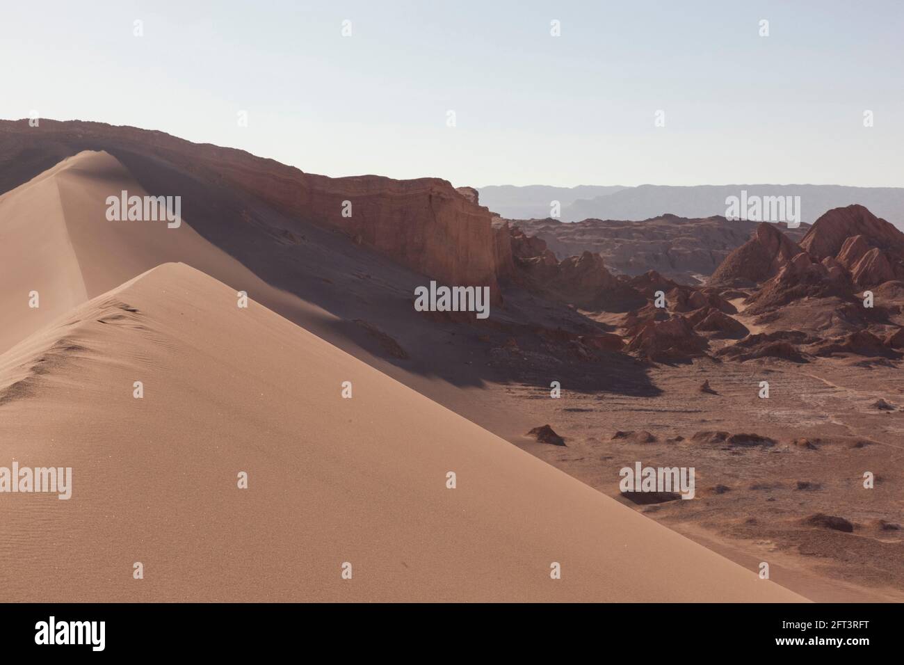 Intensely coloured sand dunes and rock faces near San Pedro De Atacama, Chile. Stock Photo