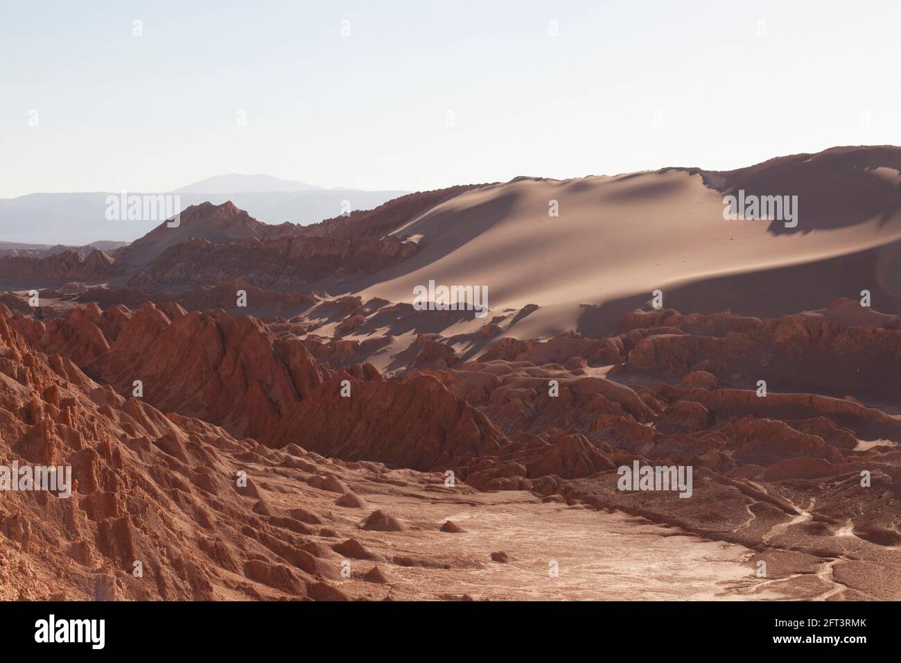 Intensely coloured sand dunes and rock faces near San Pedro De Atacama, Chile. Stock Photo