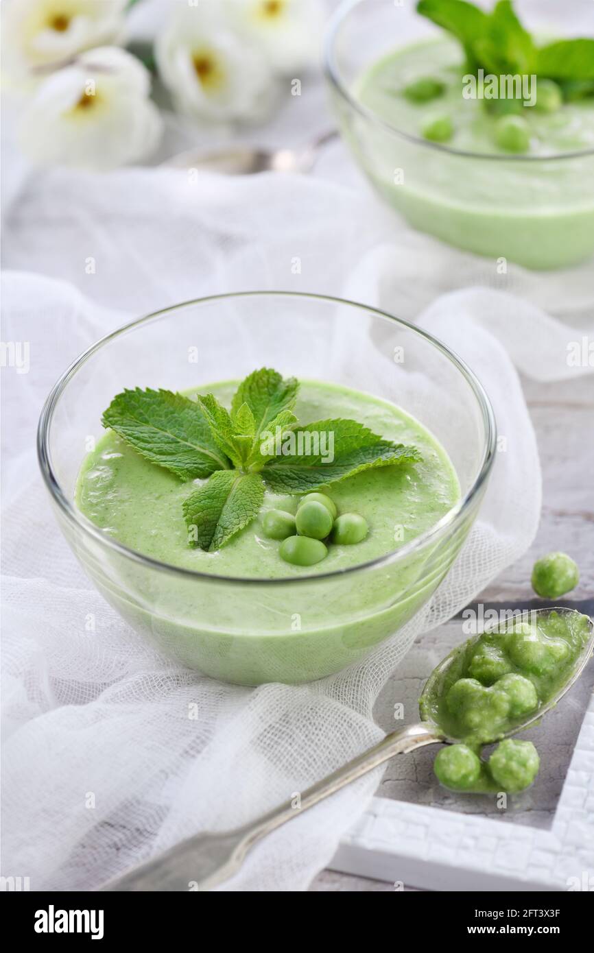 Chilled green pea puree soup with tender milk cream and refreshing mint ...