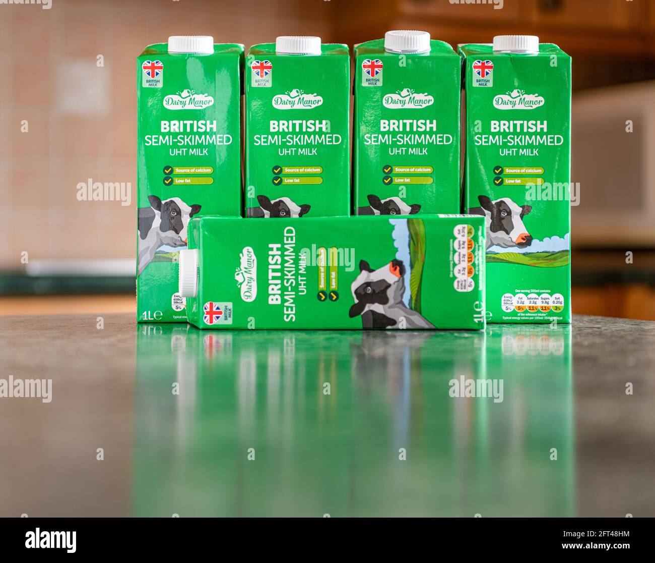 Dairy Manor SemiSkimmed Milk Tetra Pack with a blurred kitchen in the