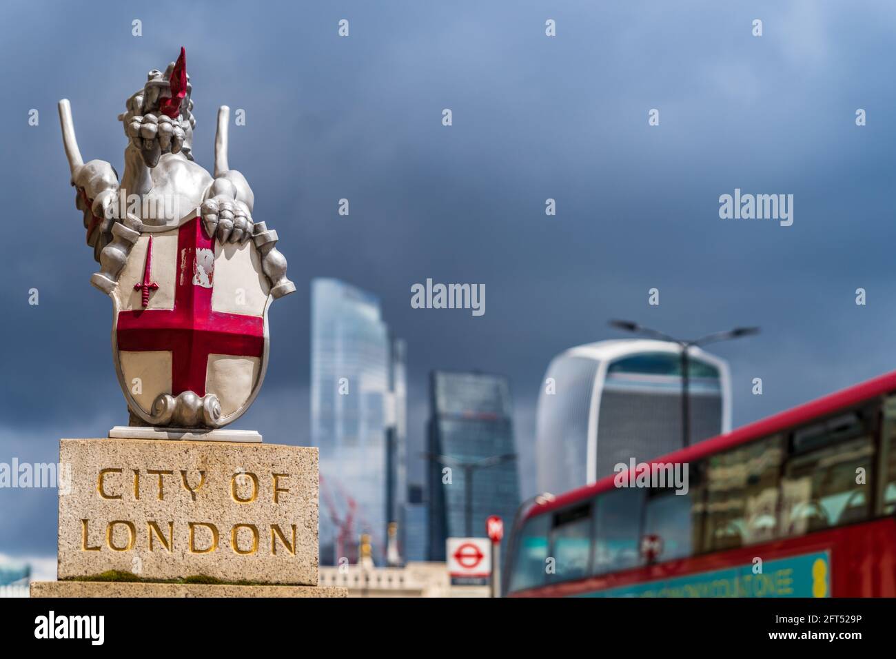 Dark Skies over the City of London Financial District. The dragon boundary markers are at entrances to the City of London Square Mile. Stock Photo