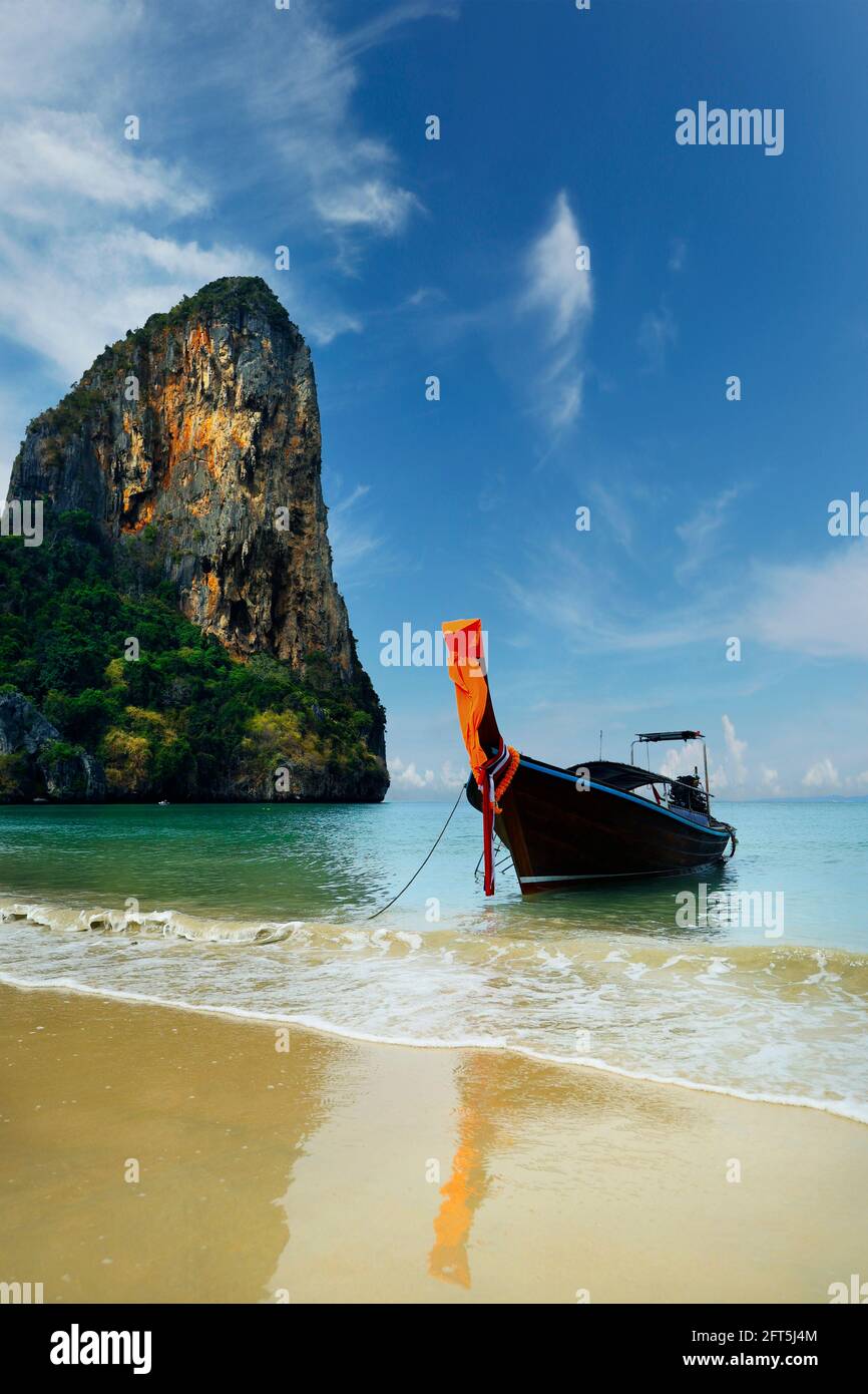 view of limestone island and long tail boat in phang nga bay in thailand Stock Photo