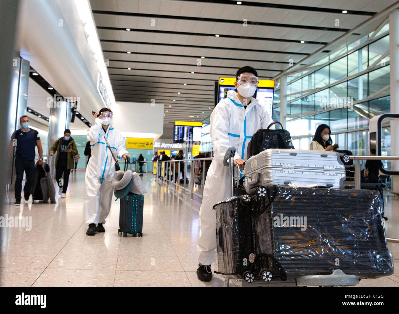 London, UK. 21st May, 2021. Passengers arriving at Heathrow Terminal 2. If you arrrive from a Green list country you must take a Covid test on or before day 2. Amber list country arrivals must quarantinein the place you are staying and take 2 Covid tests. People arriving from 'Red List' countries must quarantine at a hotel and take 2 Covid tests. Credit: Mark Thomas/Alamy Live News Stock Photo