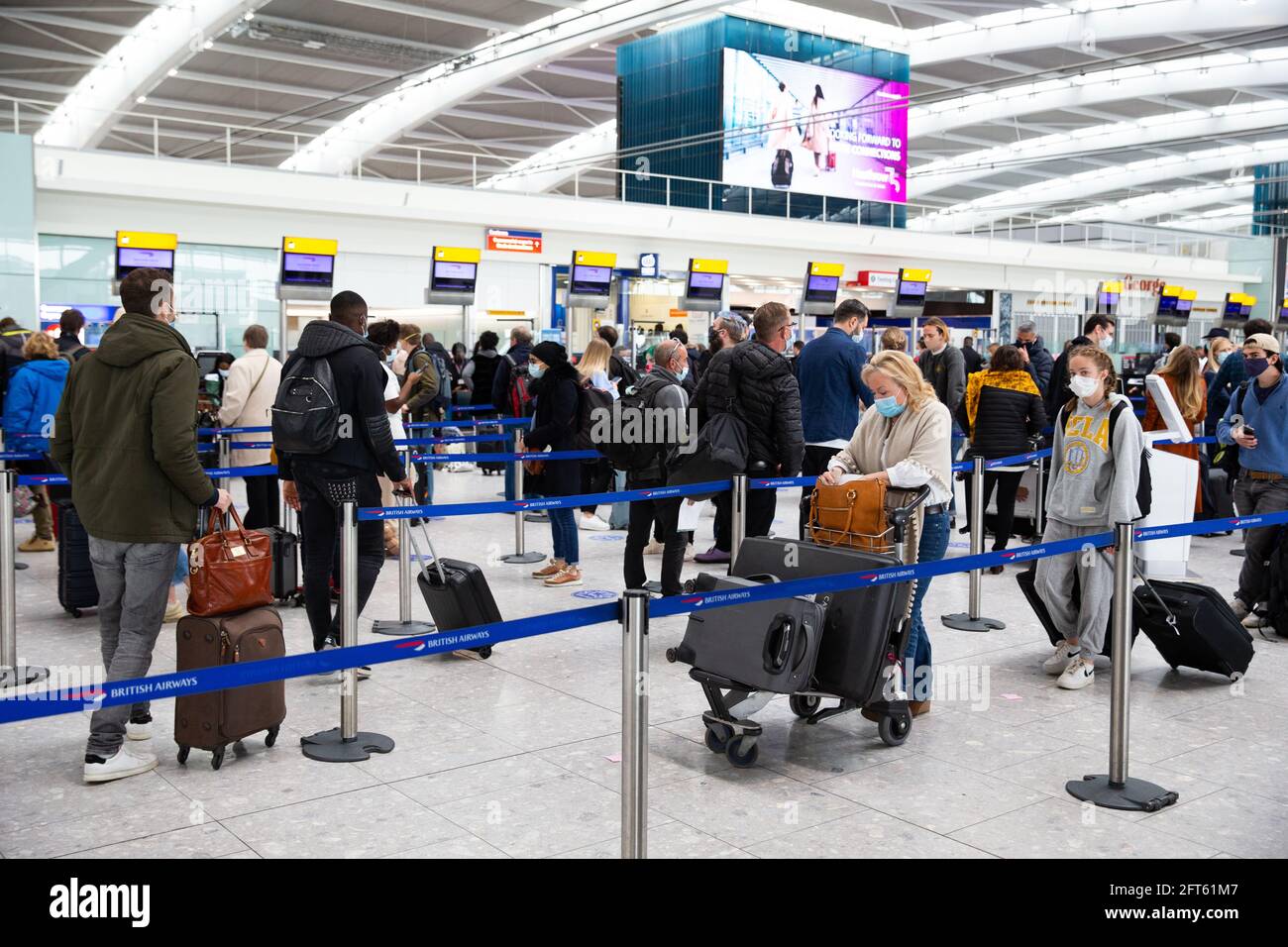 London, UK. 21st May, 2021. Passengers departing at Heathrow Terminal 5. This is a Check-In queue for a flight to Faro in Portugal which is one of the Government's 'Green list' countries. Credit: Mark Thomas/Alamy Live News Stock Photo