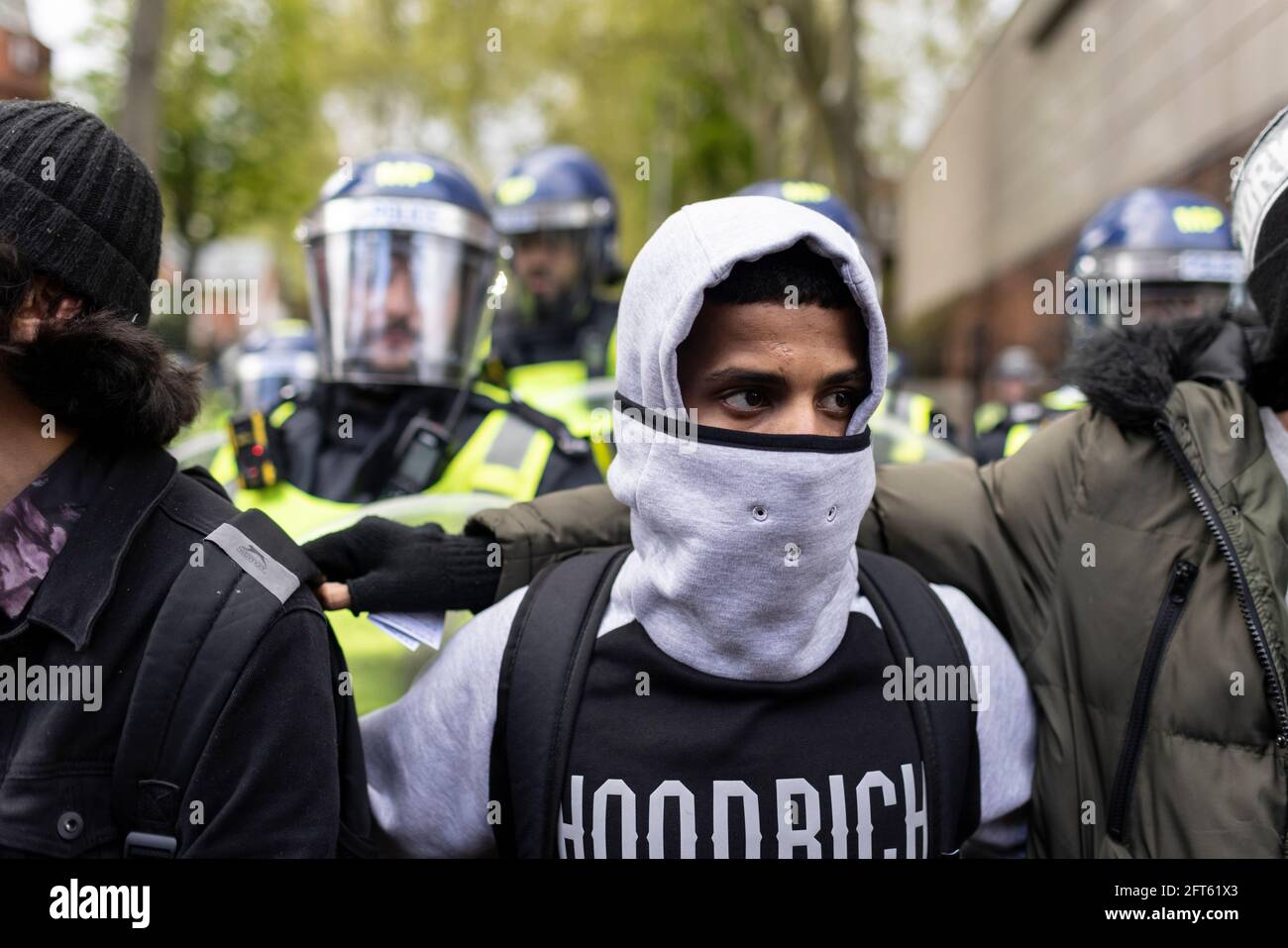 Portrait of a protester standing in front of riot police, 'Free Palestine' protest, London, 15 May 2021 Stock Photo