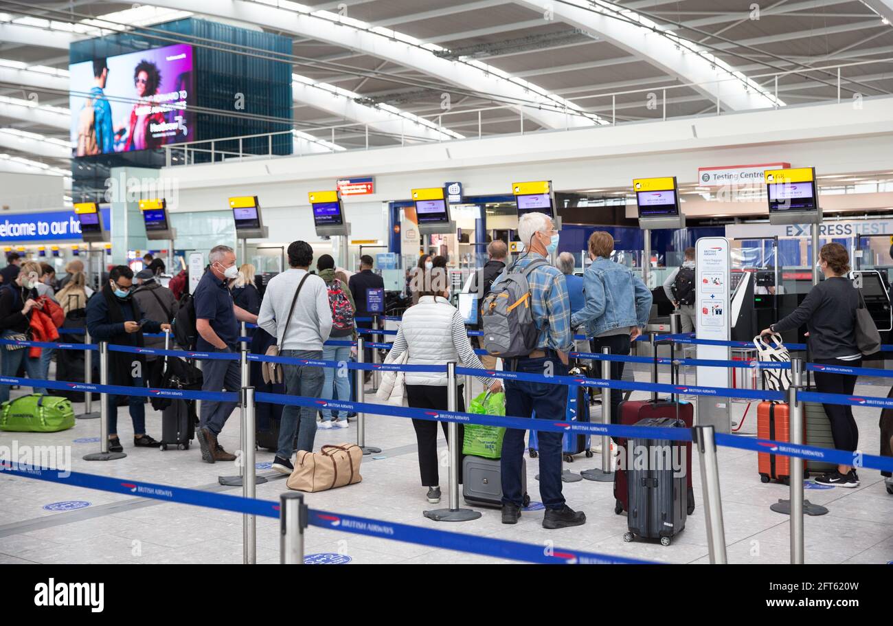 London, UK. 21st May, 2021. Passengers departing at Heathrow Terminal 5. This is a Check-In queue for a flight to Faro in Portugal which is one of the Government's 'Green list' countries. Credit: Mark Thomas/Alamy Live News Stock Photo