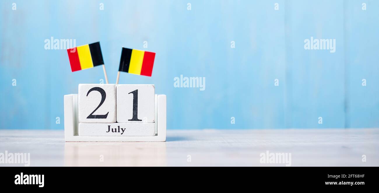 Wooden calendar of July 21th with miniature Belgium flags. Belgian