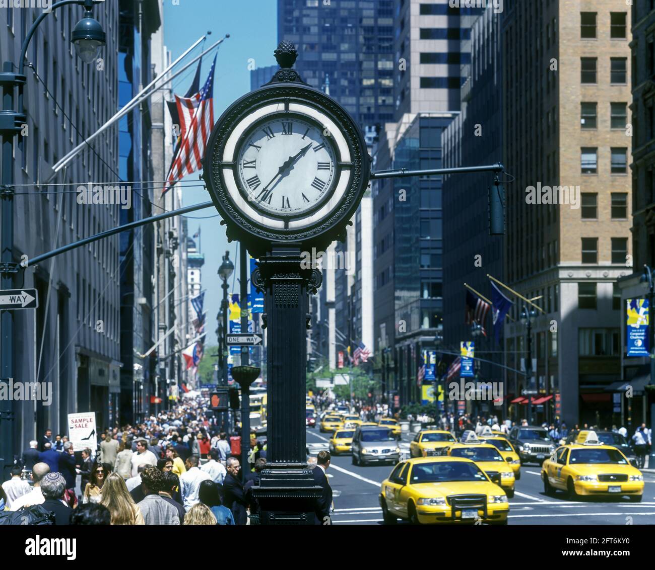 2006 HISTORICAL YELLOW TAXI CABS (©FORD MOTOR CO 2000) PUBLIC CLOCK (©SETH THOMAS CO 1920) FIFTH AVENUE MIDTOWN MANHATTAN NEW YORK CITY USA Stock Photo