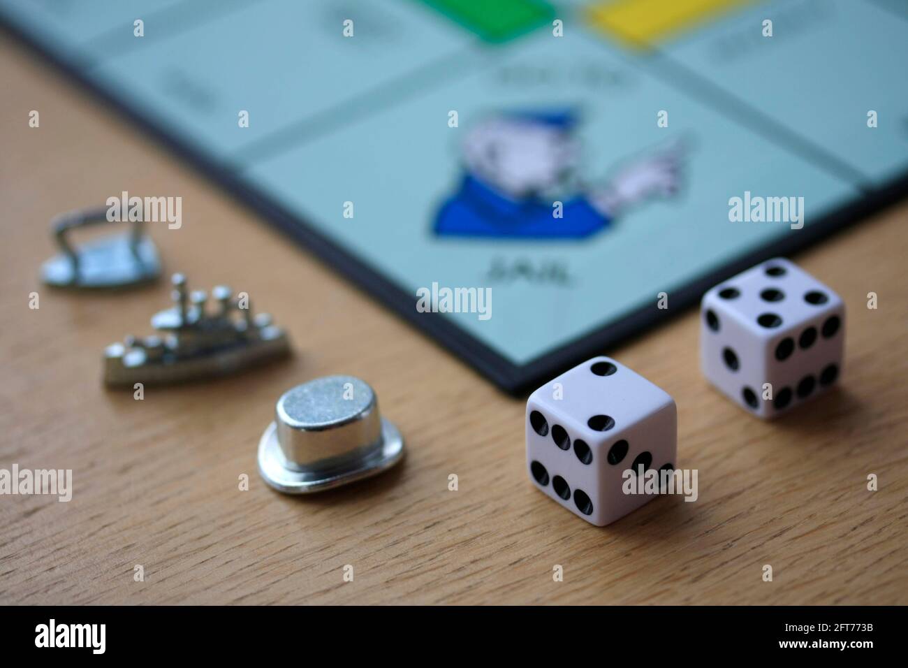 Monopoly board game pieces and dice Stock Photo