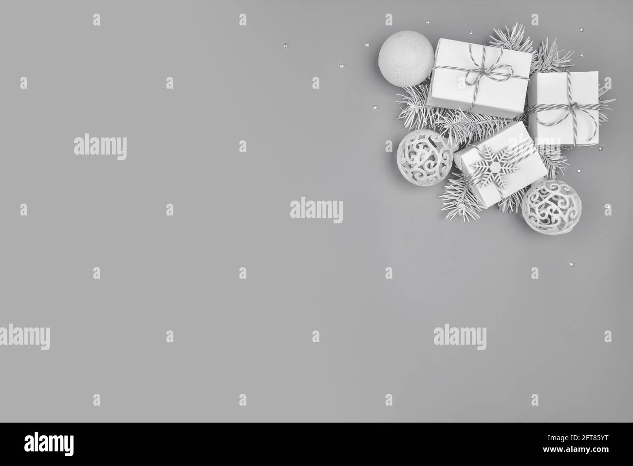 Christmas background with three gift boxes on solid gray background
