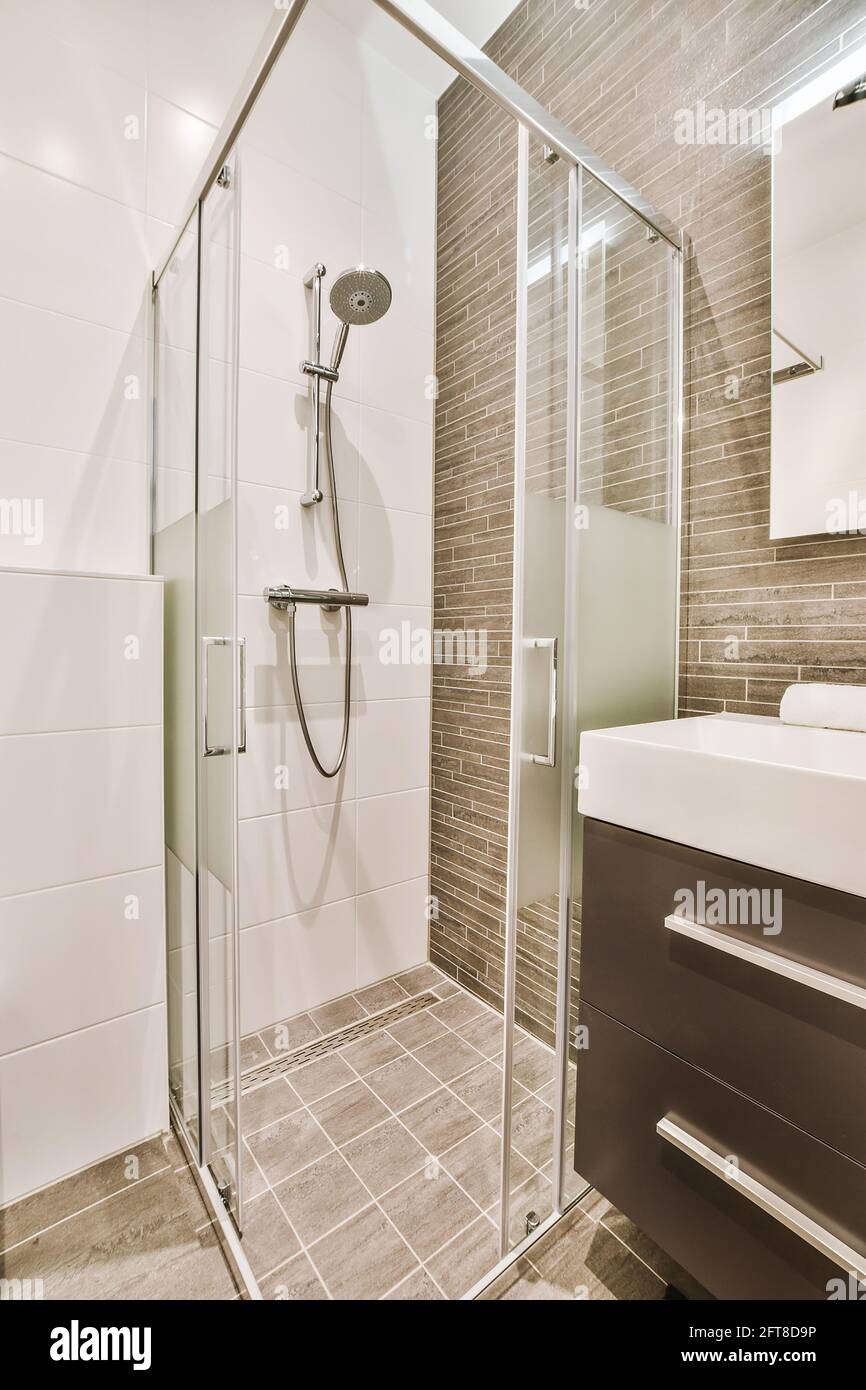 Contemporary interior design of bathroom with glass shower cabin and ...