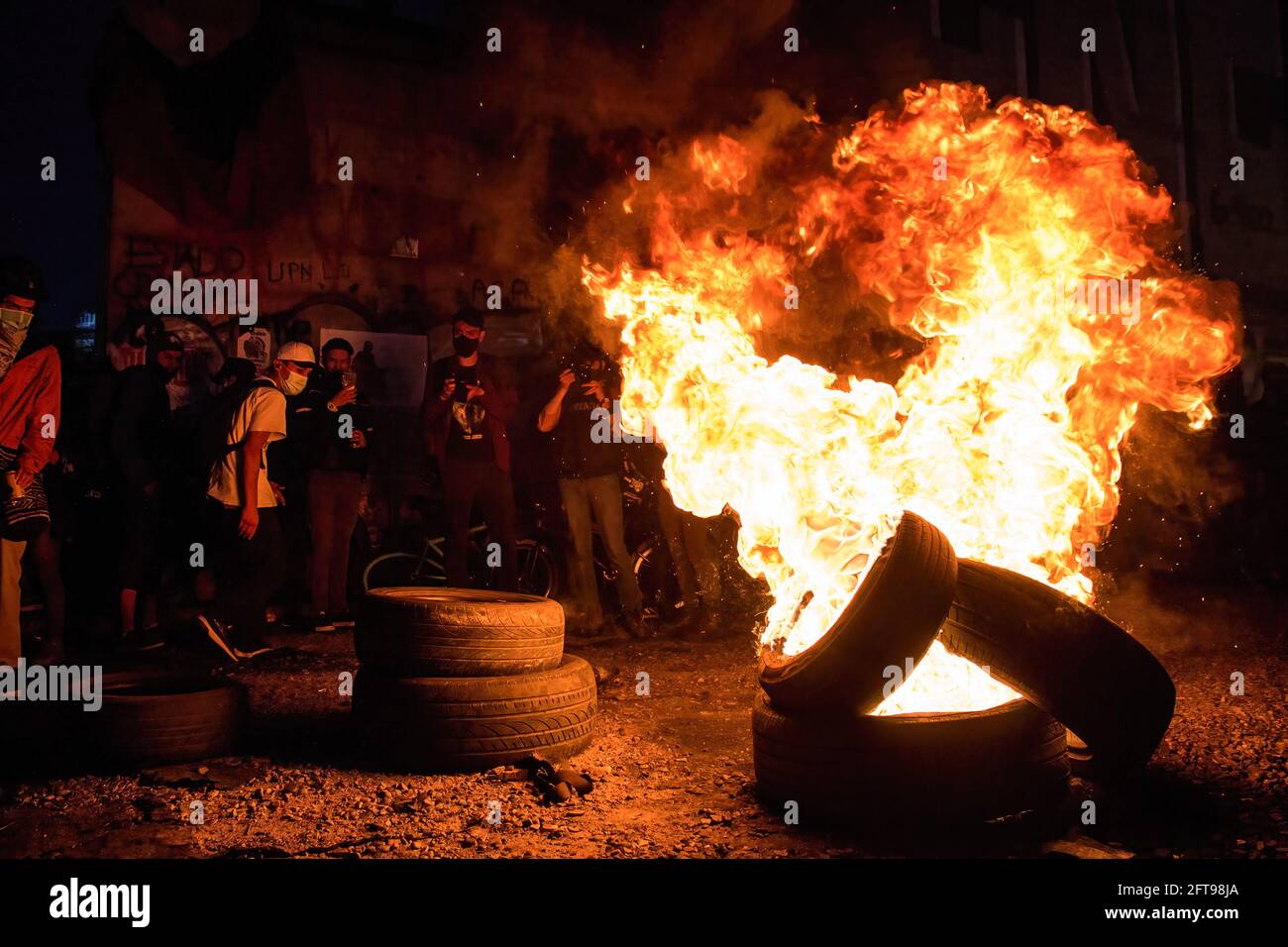 Protesters burn tires in the middle of the street during the demonstration.Plaza de Los Heroes (Heroes square) in Bogota, was one of the 40 points of demonstration during the 19M national strike. A total of fifteen thousand people took part in the strike, on the 22nd day of protest. The protests in different parts of the country began to oppose tax reform. Police have responded with extreme violence, and the demands have multiplied as the economic crisis sharpen. (Photo by Antonio Cascio/SOPA Images/Sipa USA) Credit: Sipa USA/Alamy Live News Stock Photo