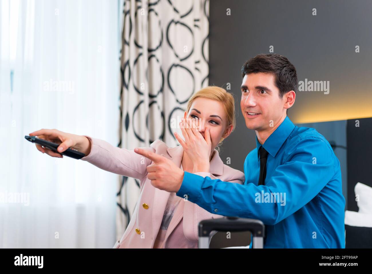 Woman hotel bed remote control hi-res stock photography and images - Alamy