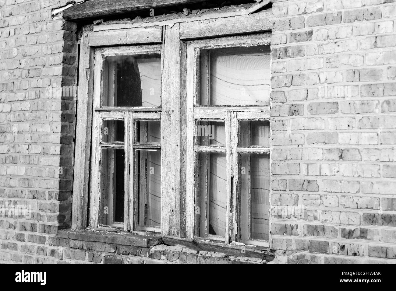 Broken Window of an old abandoned house. black and white image. Stock Photo