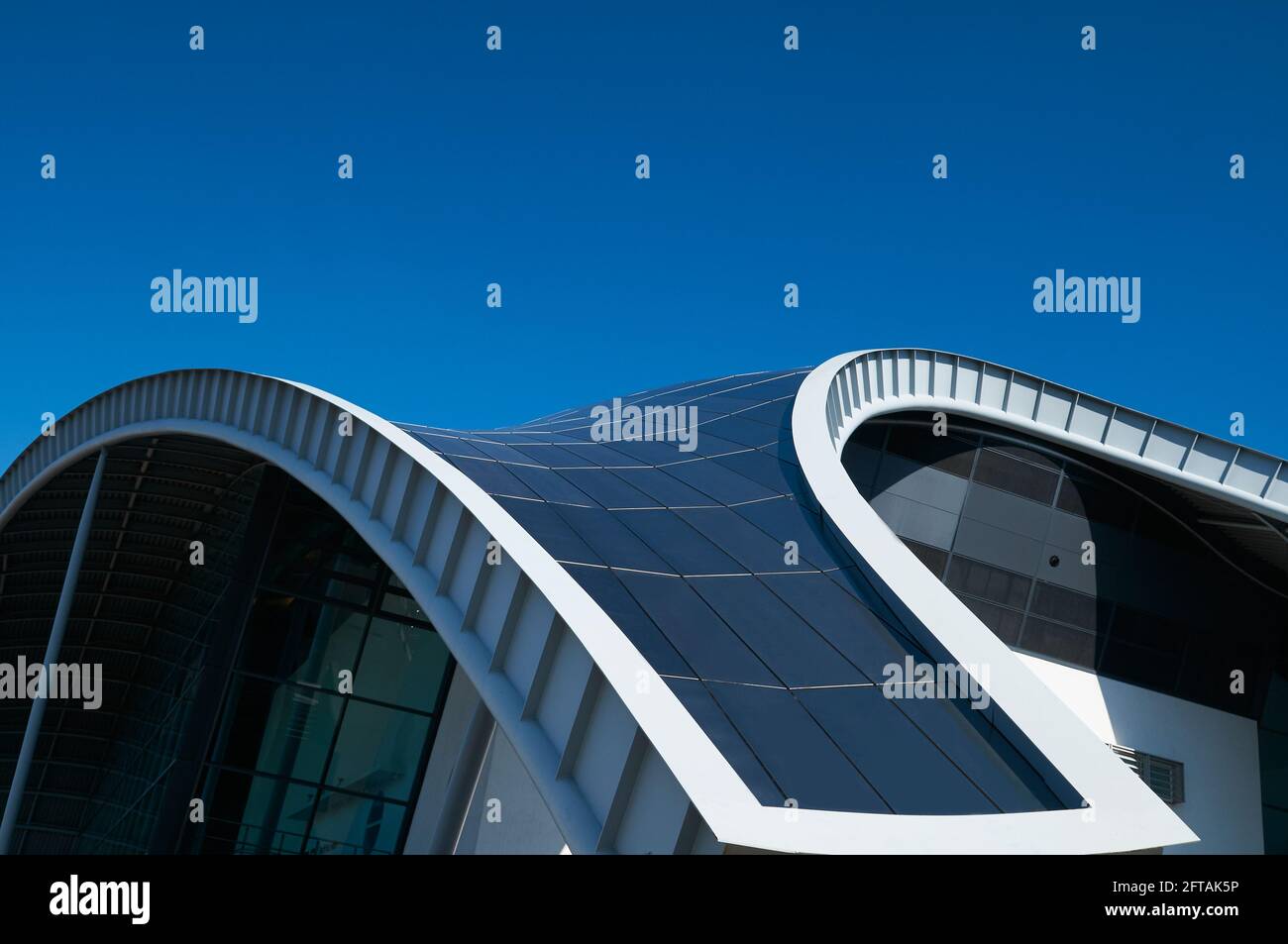 Gateshead, United Kingdom - April 6th 2019: Close-up of the curved steel roof line of the Sage building in Gateshead, against a blue sky. Stock Photo