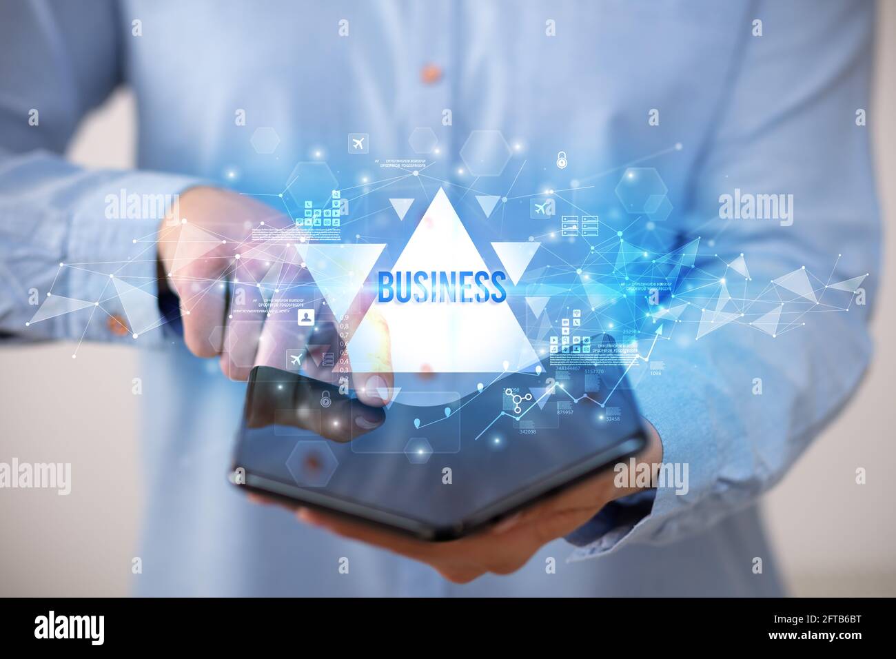 Businessman holding a foldable smartphone, business concept Stock Photo