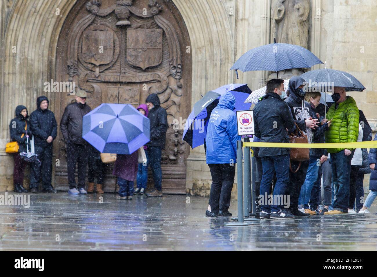 Bath, Somerset, UK. 21st May, 2021. Tourists visiting Bath and braving very heavy rain showers