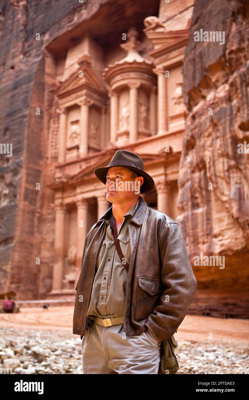 US Tourist dressed as Harrison Ford outside the Treasury  (Al-Khazneh), a location from "Indiana Jones and the last crusade". Stock Photo