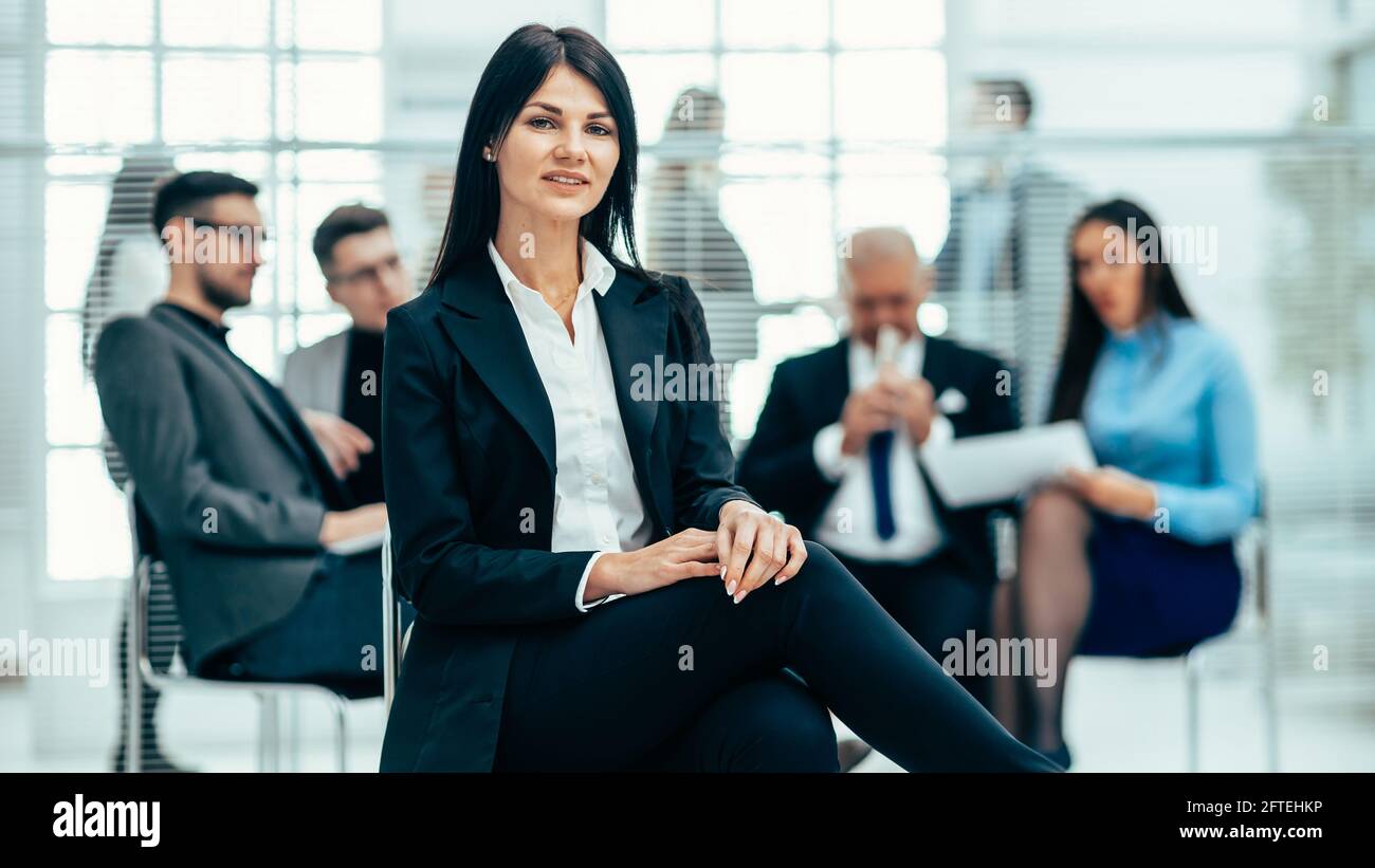 confident young business woman sitting in a modern office Stock Photo ...