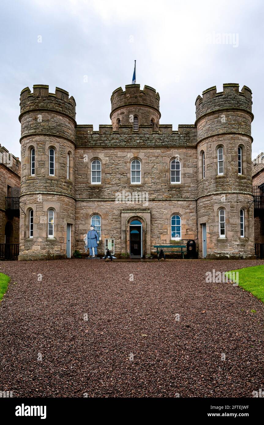 The symmetrical square Gaoler’s house at Jedburgh Old Prison with towers at each corner with battlemented parapet and moulded ashlar coping. Stock Photo