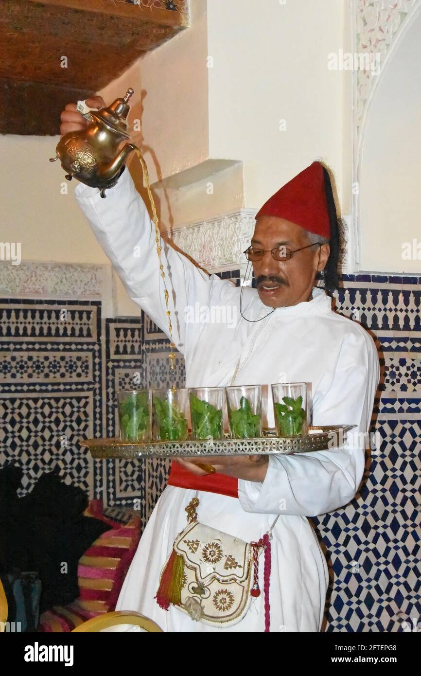 Moroccan waiter pour tea Stock Photo