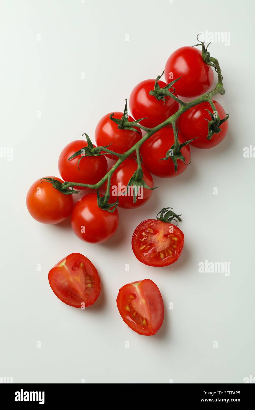 Fresh cherry tomato branch on white background Stock Photo - Alamy