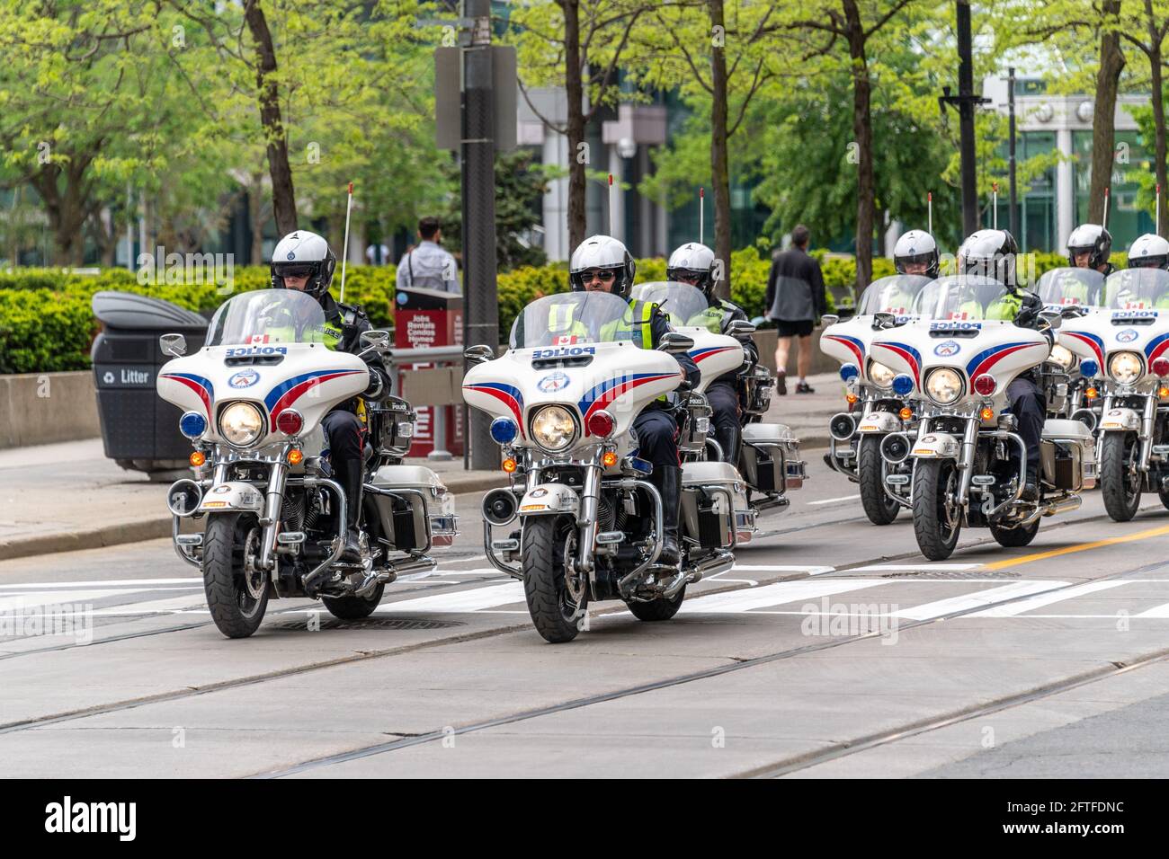 Toronto Police Department. A group of police officers is seen riding motorcycles in King Street in the Toronto downtown district, Canada Stock Photo