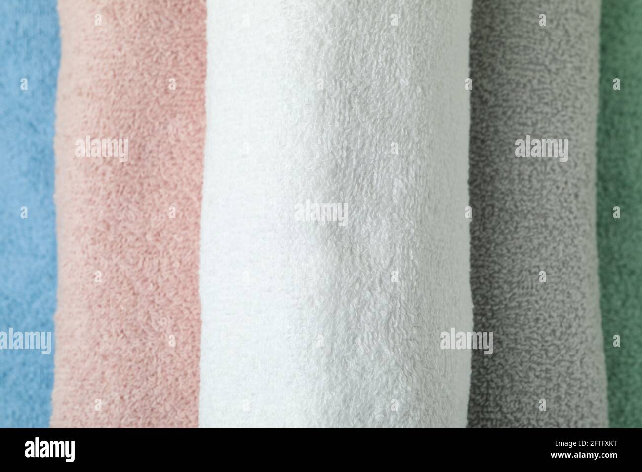 Clean multi colored rolled towels, close up Stock Photo