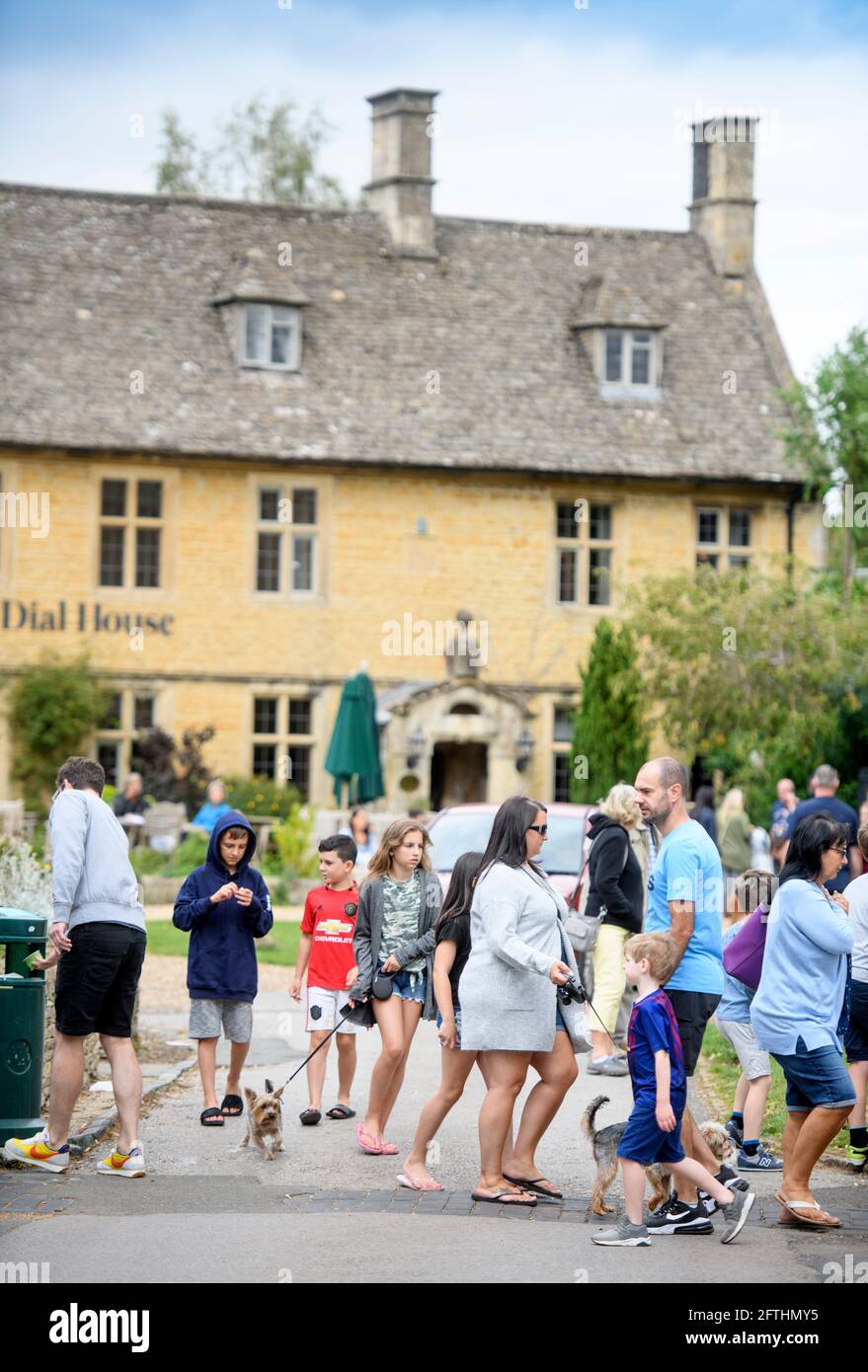 Crowds in the Cotswold village of Bourton-on-the-Water which is experiencing unprecedented visitor numbers during the Coronavirus pandemic Stock Photo