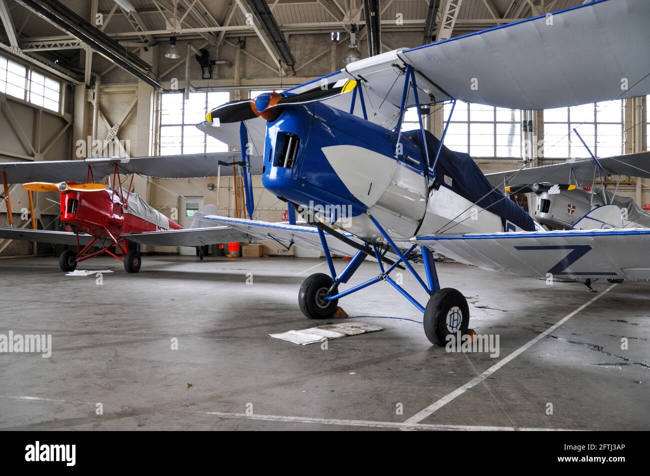 Tiger Moth planes, aircraft sheltering inside a hangar at RAF Halton, Buckinghamshire, UK, from bad weather which cancelled an anniversary flypast Stock Photo