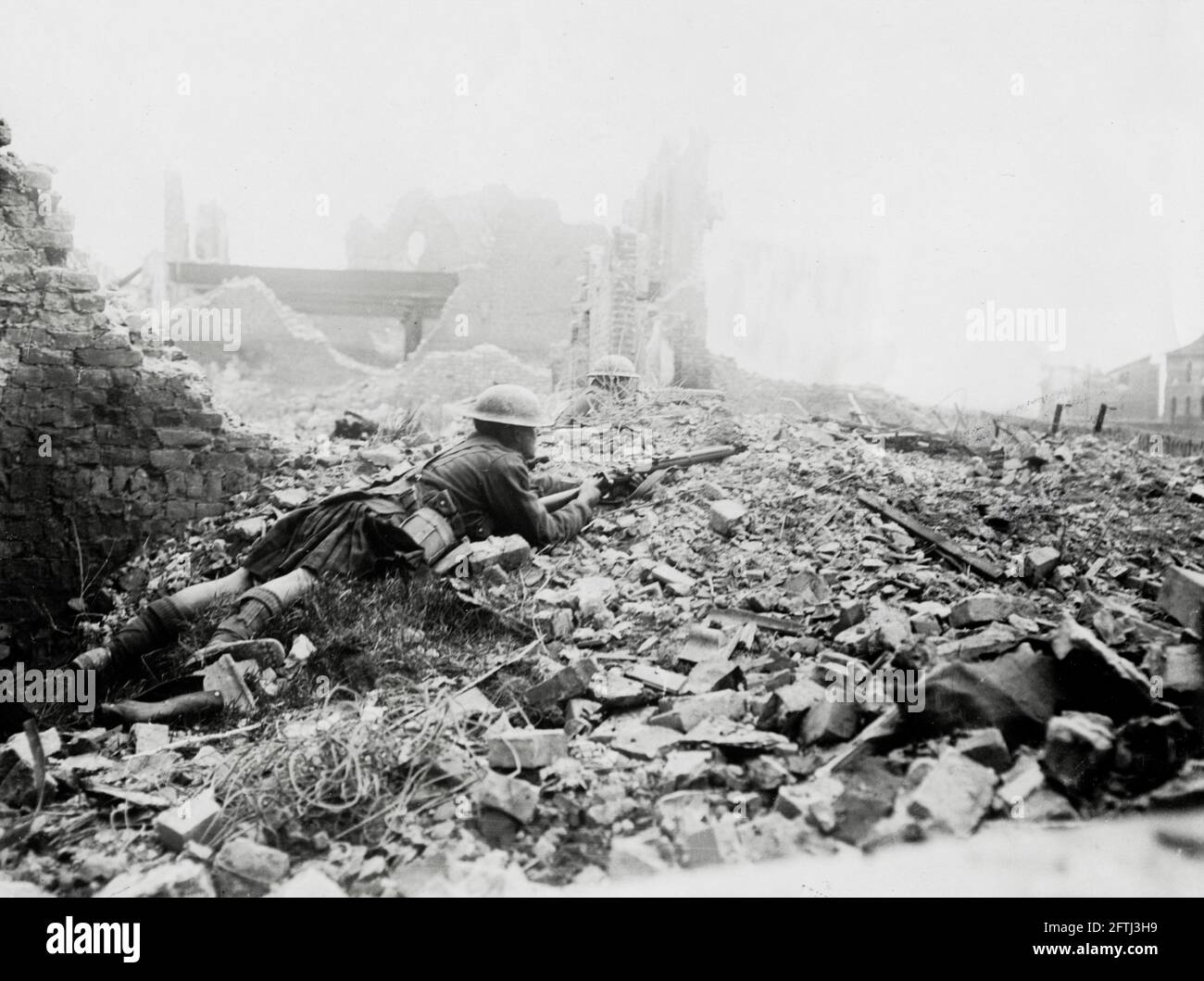 World War One, WWI, Western Front - Troops in action amidst wreckage of a shell shattered village, France Stock Photo