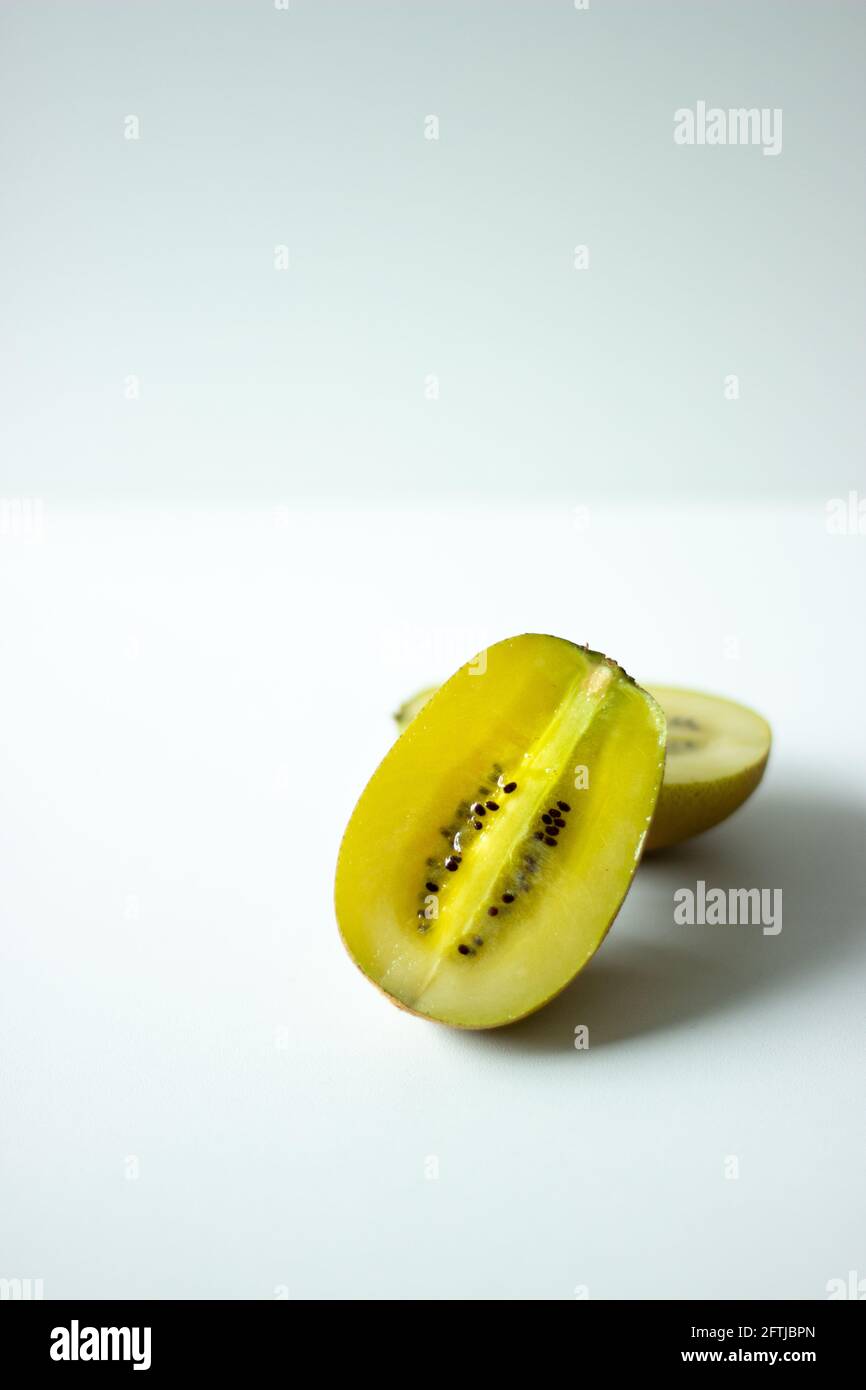 Close up of half of a golden kiwi fruit on white background; isolated kiwi; exotic fruit Stock Photo