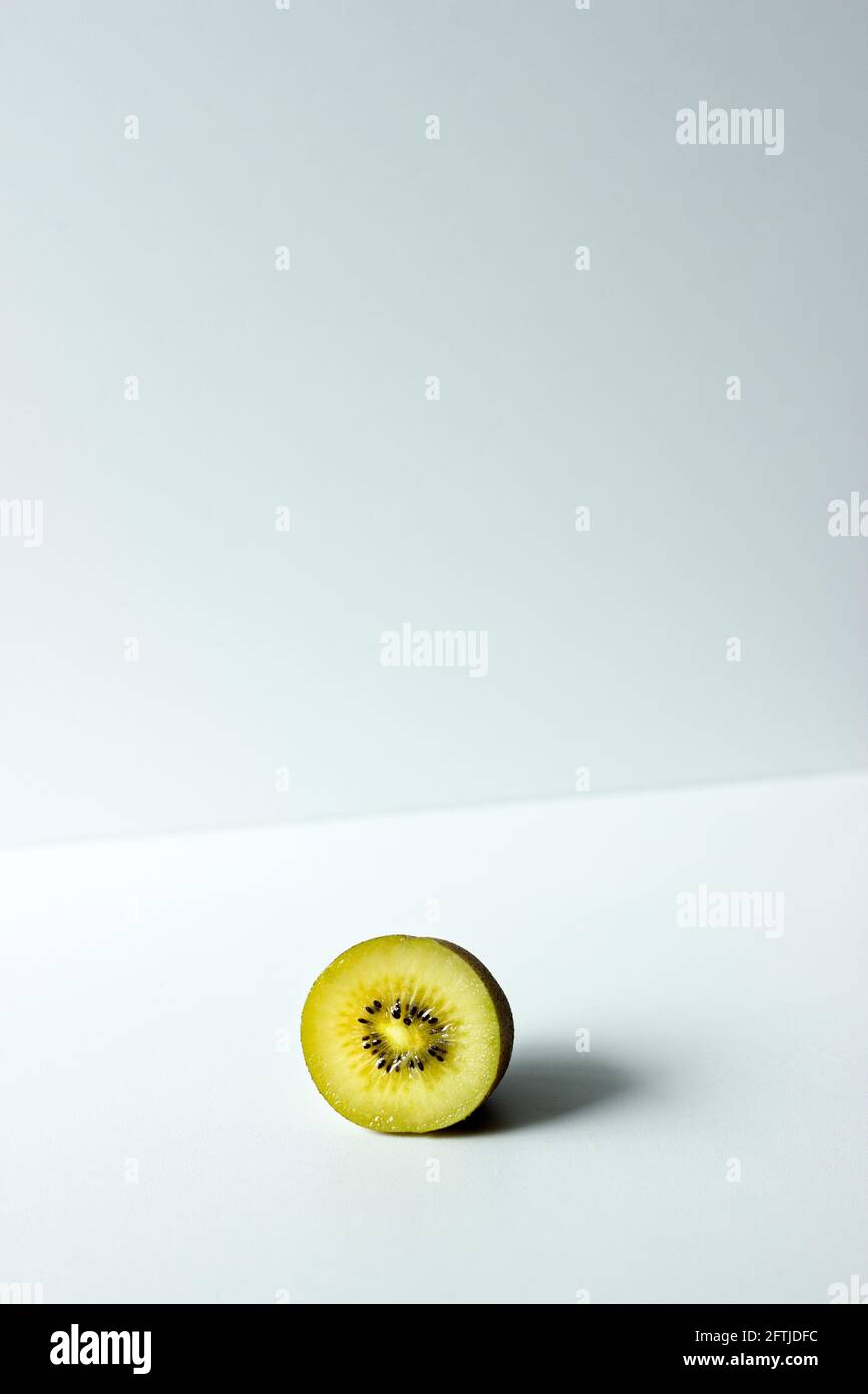 Close up of half of a golden kiwi fruit on white background; isolated kiwi; exotic fruit Stock Photo