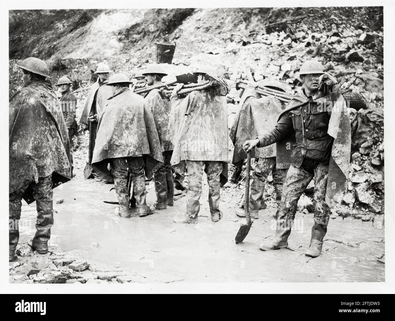 World War One, WWI, Western Front - A working party about to start off in the rain wearing waterproof sheets and trench waders, France Stock Photo
