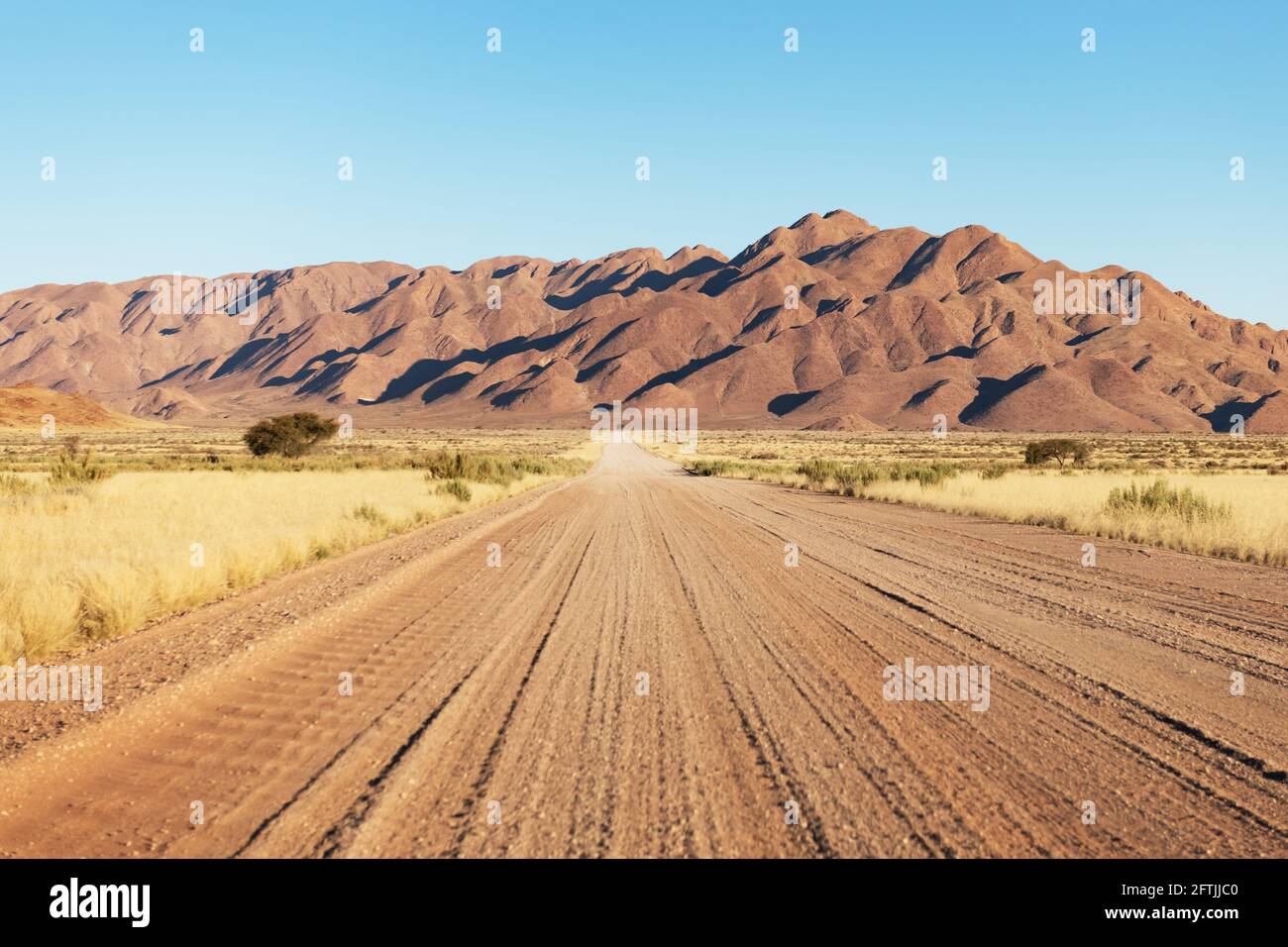 Gravel road and beautiful landscape with sunset sky Stock Photo